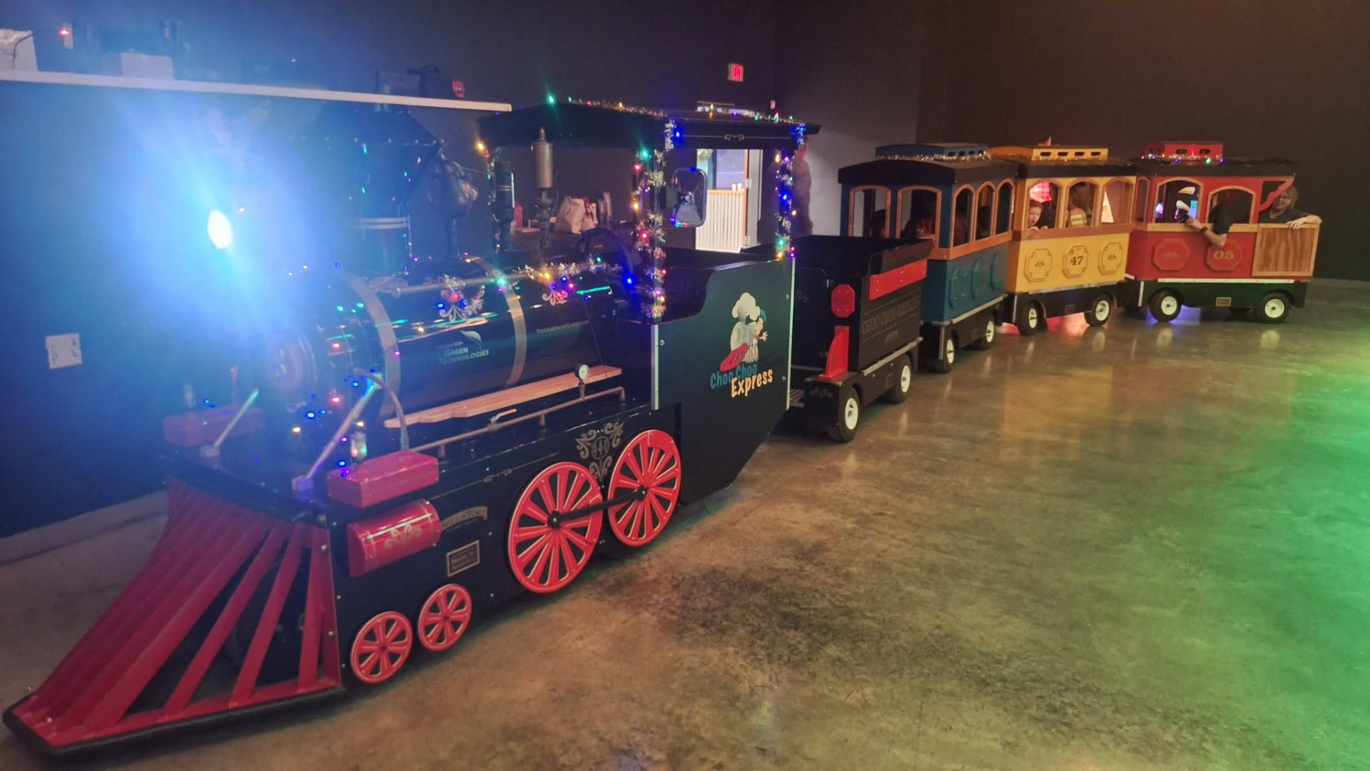 Kids waving from the Choo Choo Express train cars