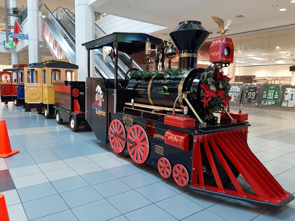 The First Class Electric locomotive trimmed with holiday garland inside a shopping mall