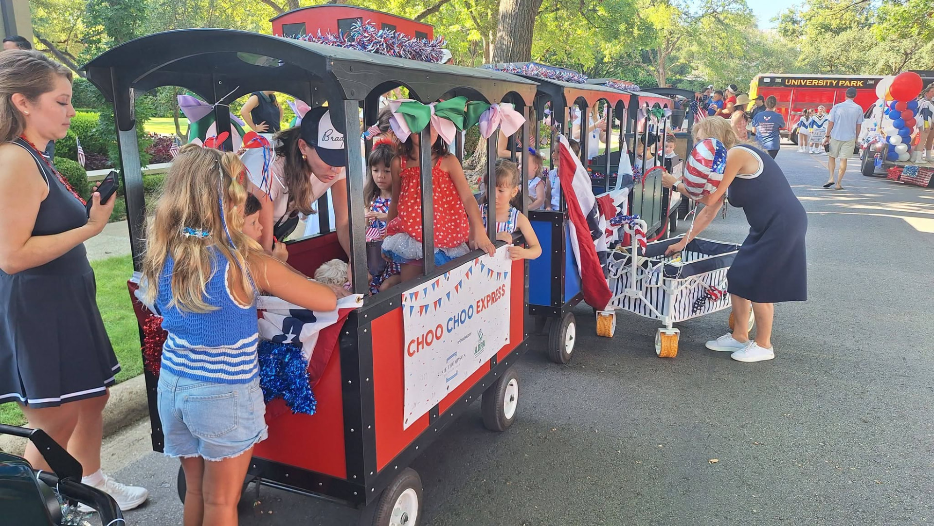 Kids waving from the Choo Choo Express train cars